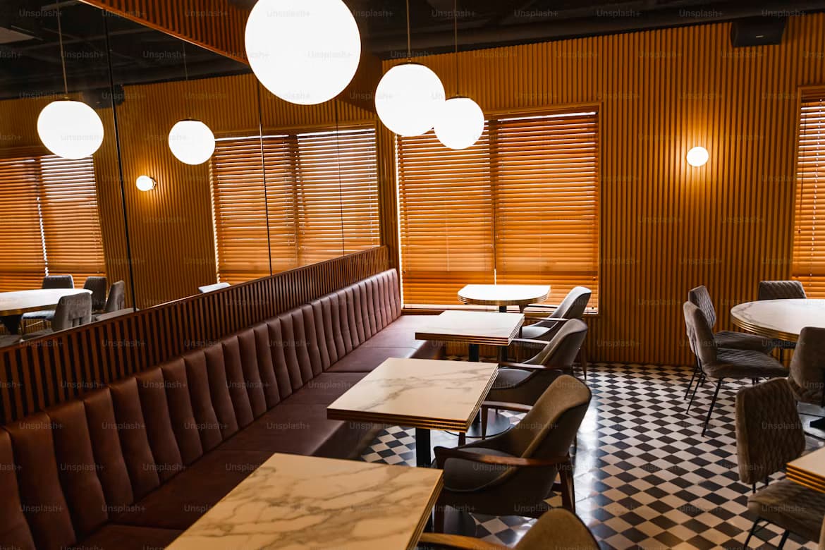 Warm café interior with booth seating and marble tables
