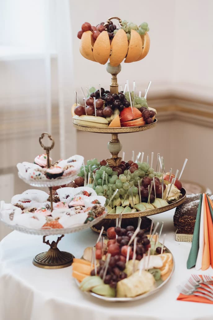 Professional event catering display with fruit and assorted desserts